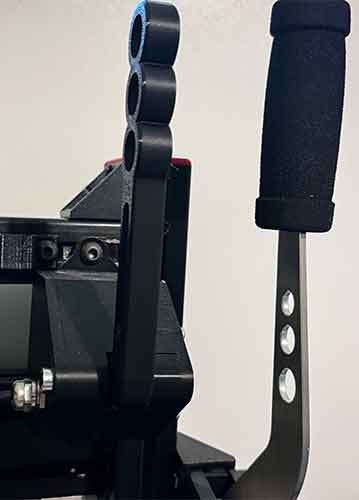 Close-up of a sim racing sequential gear shifter and handbrake featuring industrial grade build and design.